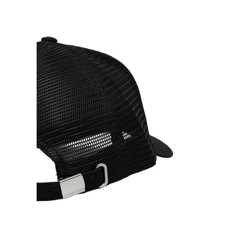 Black mesh trucker cap with silver Calvin Klein branded buckle and adjustable strap back in cotton material