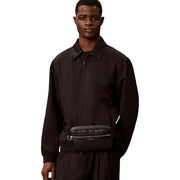 Black textured leather Calvin Klein men perforated waistbag with silver zippers and subtle logo detail in polyurethane