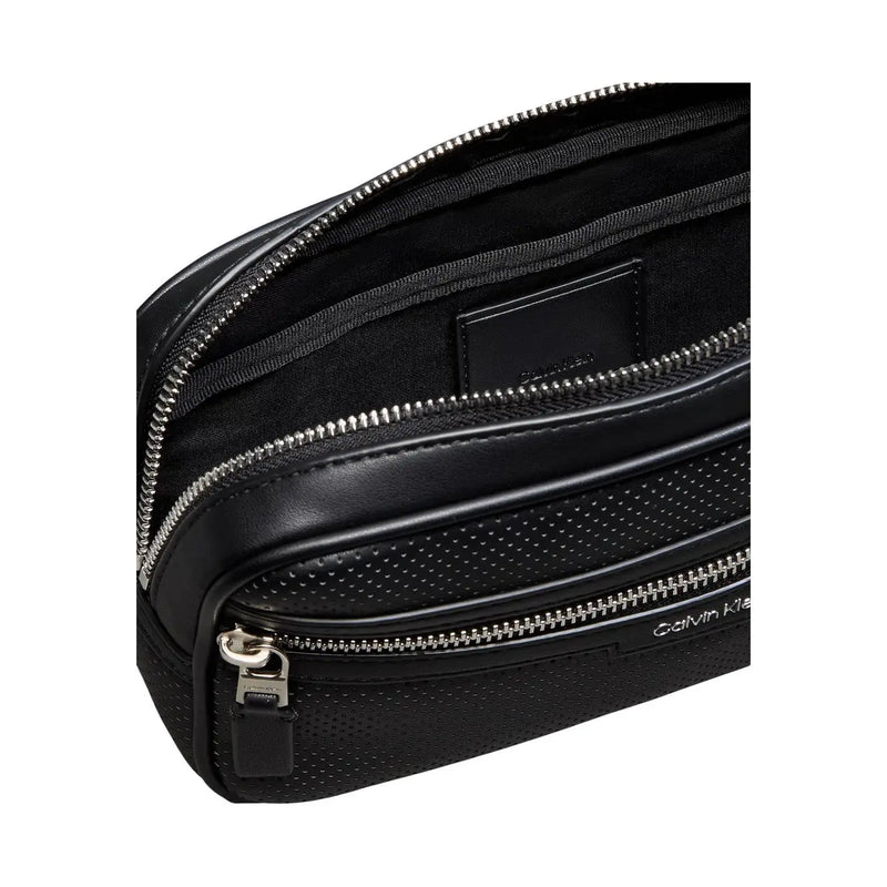Calvin Klein men perforated black crossbody bag made of polyurethane with silver zippers and compact design