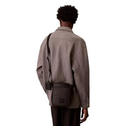 Calvin klein men puffer utility reporter bag black crossbody with quilted texture and rectangular logo patch