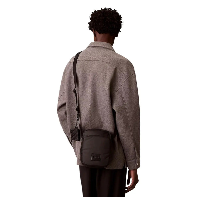 Calvin klein men puffer utility reporter bag black crossbody with quilted texture and rectangular logo patch