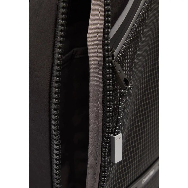 Calvin Klein men shoulder bag black polyamide with textured grid pattern and gray zipper pulls 20x36x5 cm