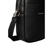 Calvin Klein men shoulder bag in black textured leather with silver-toned zipper and adjustable crossbody strap