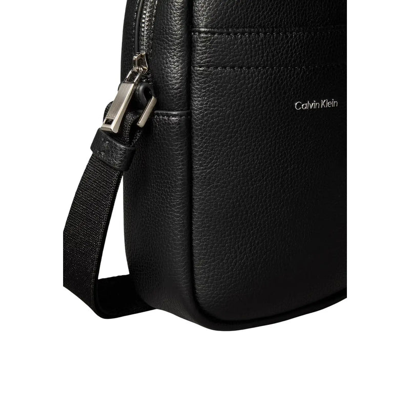 Calvin Klein men shoulder bag in black textured leather with silver-toned zipper and adjustable crossbody strap