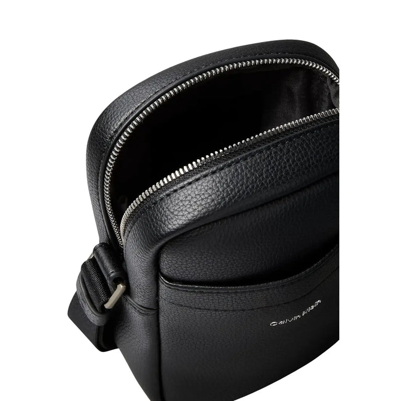 Calvin Klein men shoulder bag in black textured polyurethane leather with silver zipper and adjustable crossbody strap