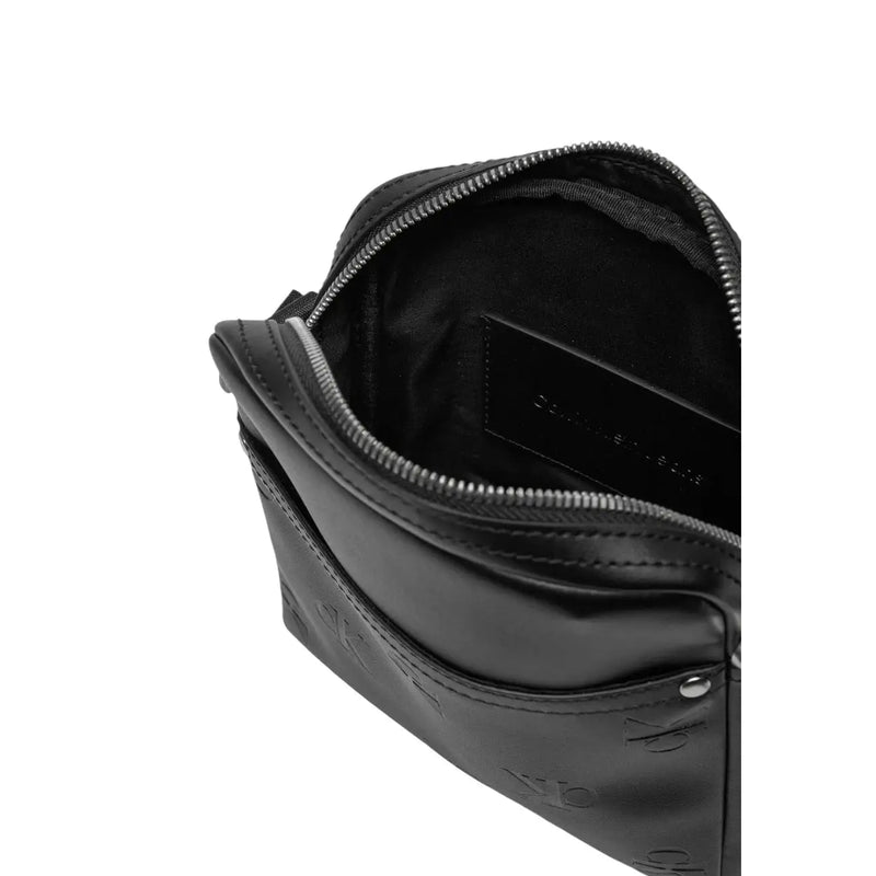 Black Calvin Klein logo embossed leather crossbody bag with silver-toned zipper for men shoulder use poly W18 x H21 cm