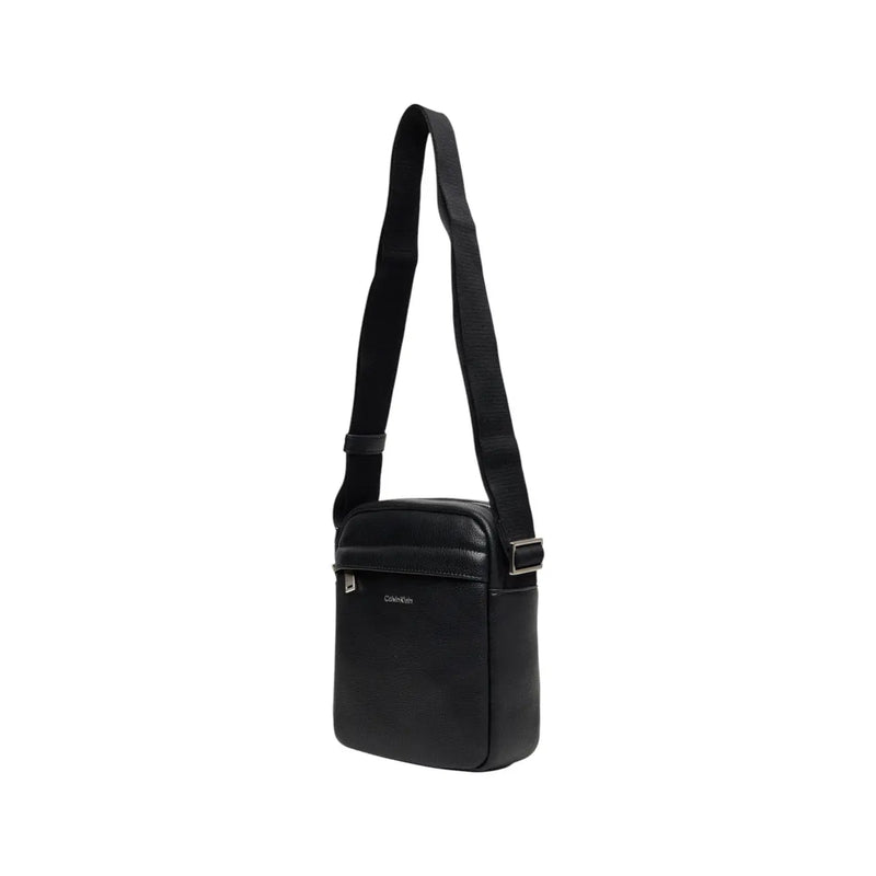 Calvin Klein men shoulder bag in black leather with zip pockets and silver hardware measuring 18x23x7 cm