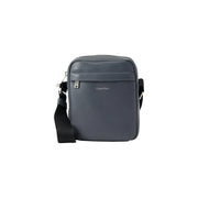 Dark gray Calvin Klein men shoulder bag with black strap, silver hardware, and black zip pockets measuring 18x23x7 cm