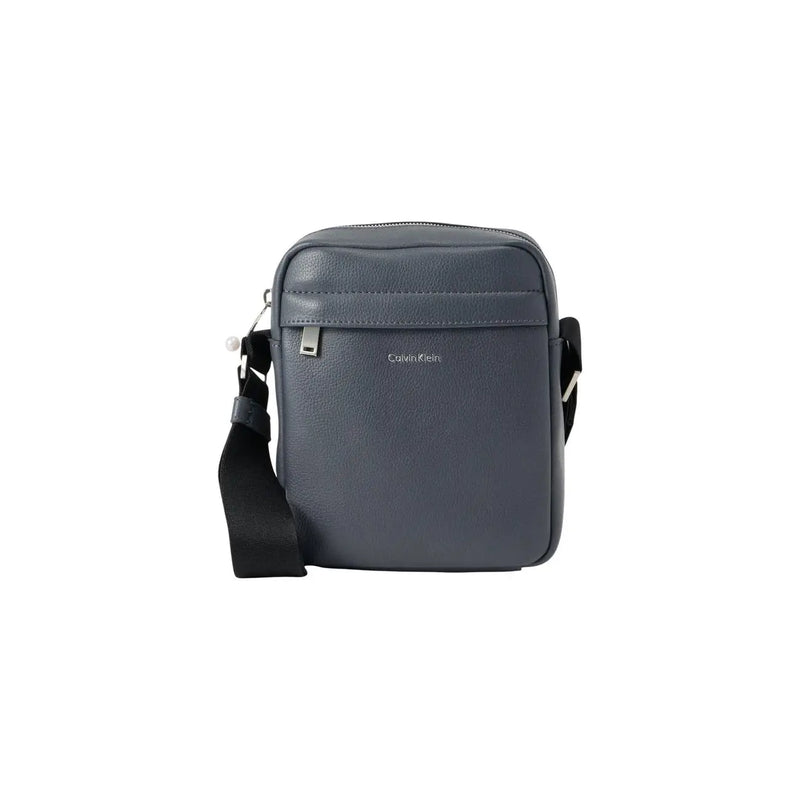 Dark gray Calvin Klein men shoulder bag with black strap, silver hardware, and black zip pockets measuring 18x23x7 cm