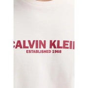 White Calvin Klein men t-shirt with bold red Calvin Klein and established 1968 lettering across the chest
