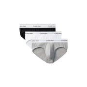 Calvin Klein Slips pour hommes, disponibles en noir, blanc et gris chiné, avec ceinture élastique signature.