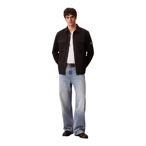 Calvin Klein mens black cotton button-up shirt with long sleeves two chest pockets and subtle sleeve logo patch
