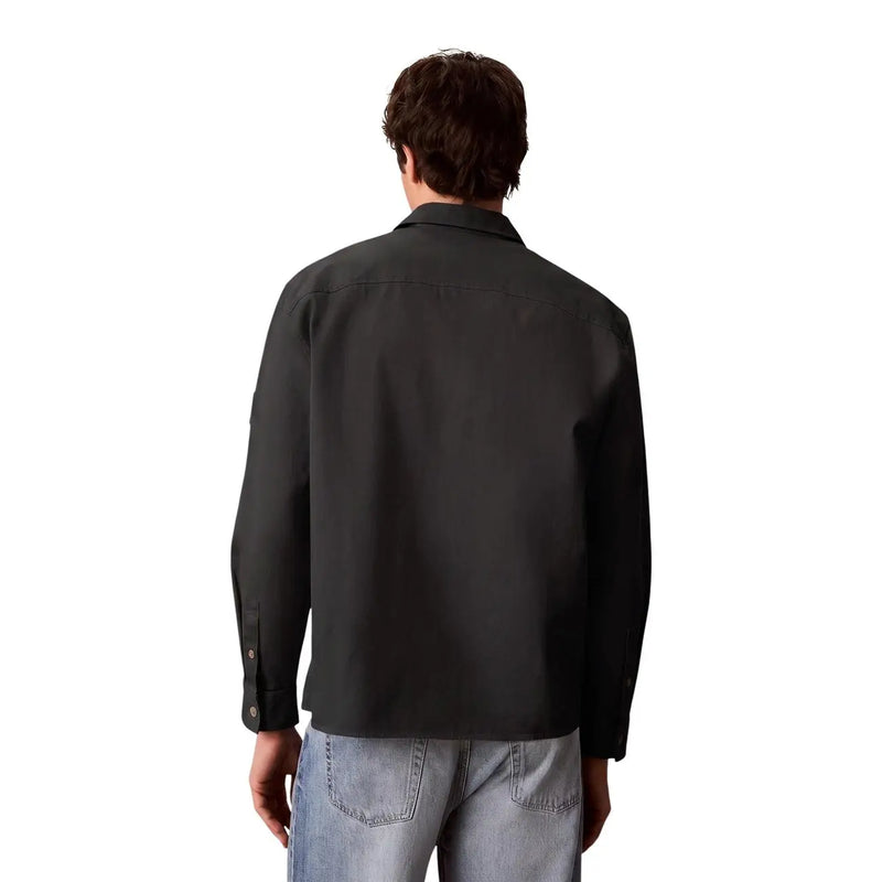 Calvin Klein Chemise noire à manches longues en coton pour homme, avec col classique et détails de couture discrets.