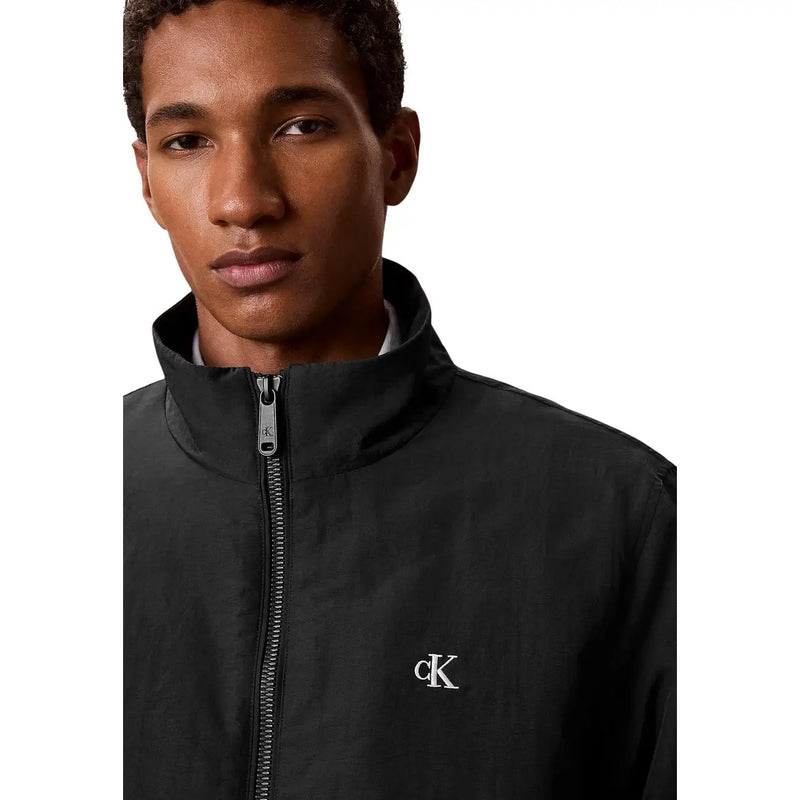 Calvin Klein mens black nylon blazer jacket featuring a track jacket design with white embroidered logo and silver zipper