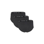 Three pairs of black Calvin Klein men’s briefs with branded waistbands on display