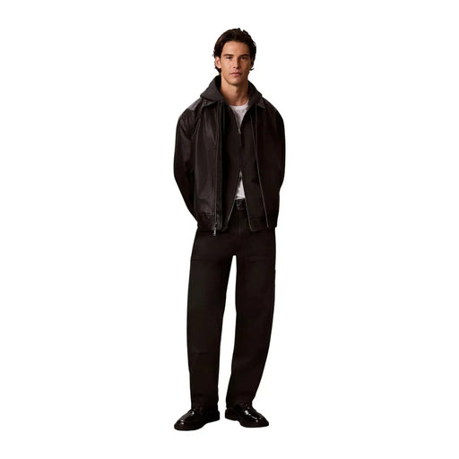 Black leather bomber jacket with hood and front zipper shown with calvin klein mens grey cotton hooded sweatshirt