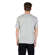 Man wearing Calvin Klein Sport grey round neck T shirt and black cargo pants