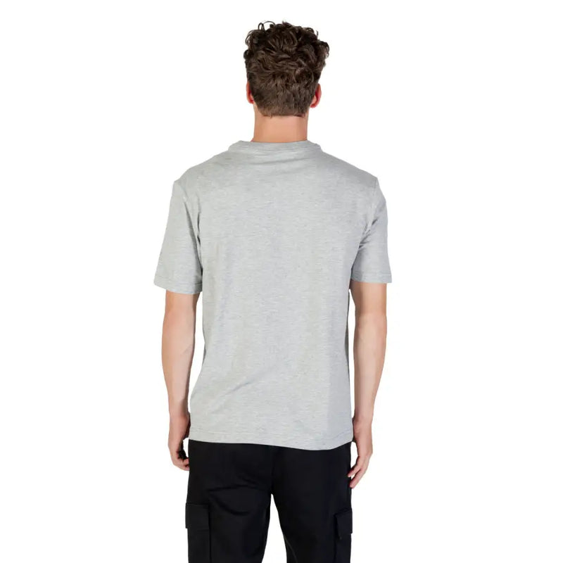 Man wearing Calvin Klein Sport grey round neck T shirt and black cargo pants