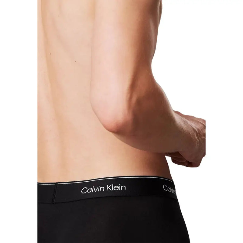 Calvin Klein men underwear in black with a white waistband featuring silver Calvin Klein logo lettering