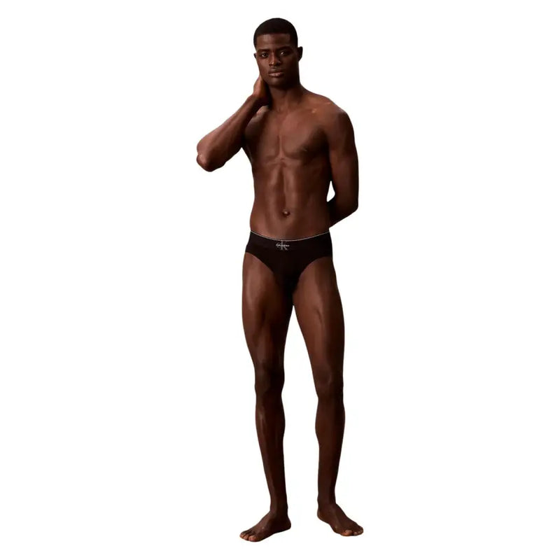 Black Calvin Klein men’s briefs with white logo waistband made from soft cotton for comfortable daily wear