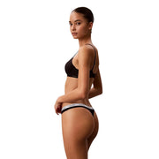 Black calvin klein women cotton thong underwear with white elastic waistband featuring the brand logo