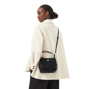 Black textured leather Calvin Klein women crossbody bag with silver-tone hardware and adjustable strap in polyurethane