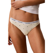 Cream-colored calvin klein bikini briefs with cotton fabric, white waistband logo, and black star patterns, part of 5 pack set