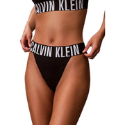 Black Calvin Klein women high leg thong bikini bottom in polyester elastane with white logo waistband shown from the back