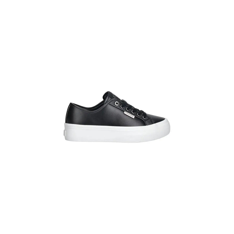 Calvin Klein women leather sneaker in black with a white platform sole and silver eyelets low top design