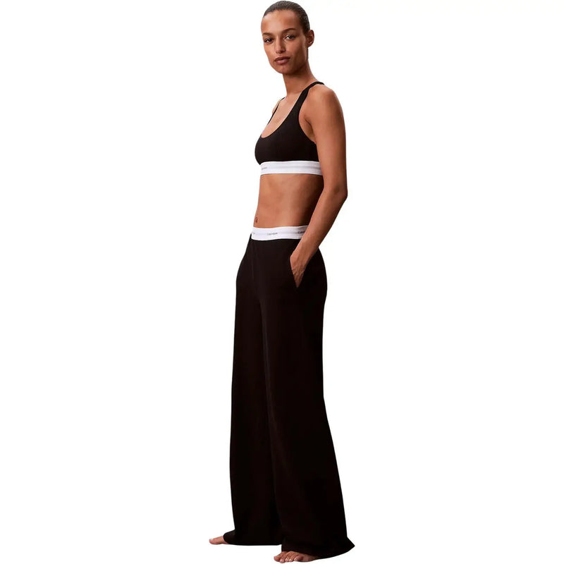 Black wide-leg cotton jersey pants for women with a white calvin klein logo waistband for underwear use