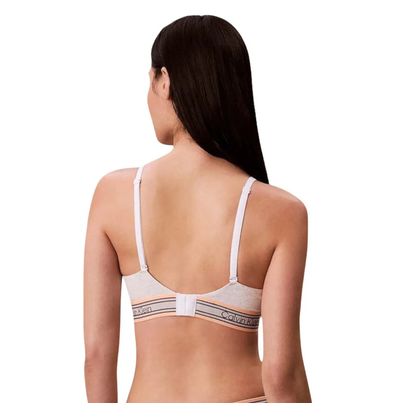 Calvin Klein women lightly lined triangle bra with white straps and peach cotton band featuring brand logo