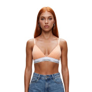 Peach-colored Calvin Klein lightly lined triangle bra with white cotton band featuring black logo text