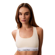 Cream-colored calvin klein unlined sports bra with white modal cotton elastic band featuring brand logo