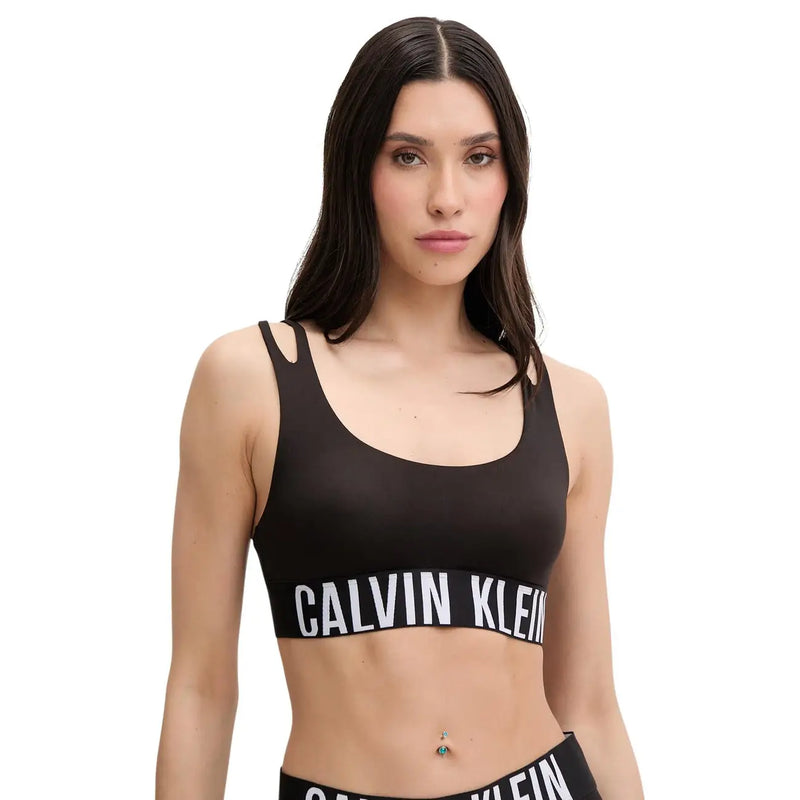Black Calvin Klein sports bra with white logo band across the chest made of cotton modal for women