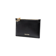Black Calvin Klein women wallet made of faux leather with zippered card case and gold-tone hardware and logo