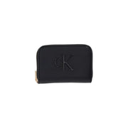 Black Calvin Klein women’s wallet made of polyurethane with zippered closure, embossed logo, and gold-tone zipper pull