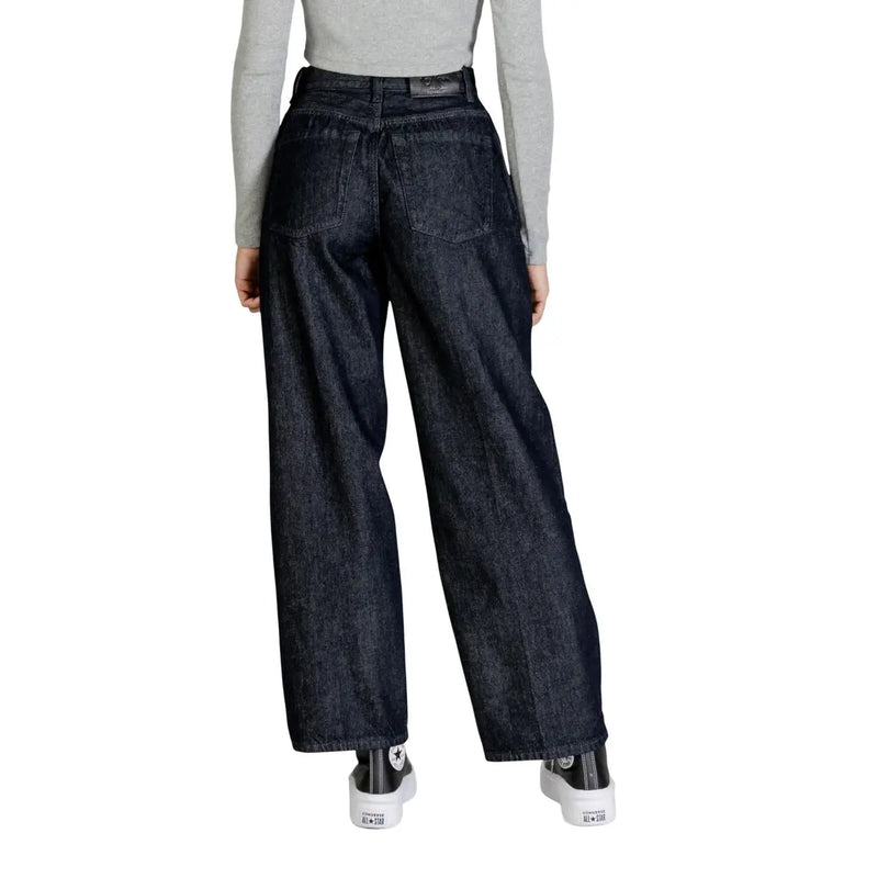 Dark indigo cotton wide-leg jeans with high waist and classic back pockets shown from the back by Calvin Klein
