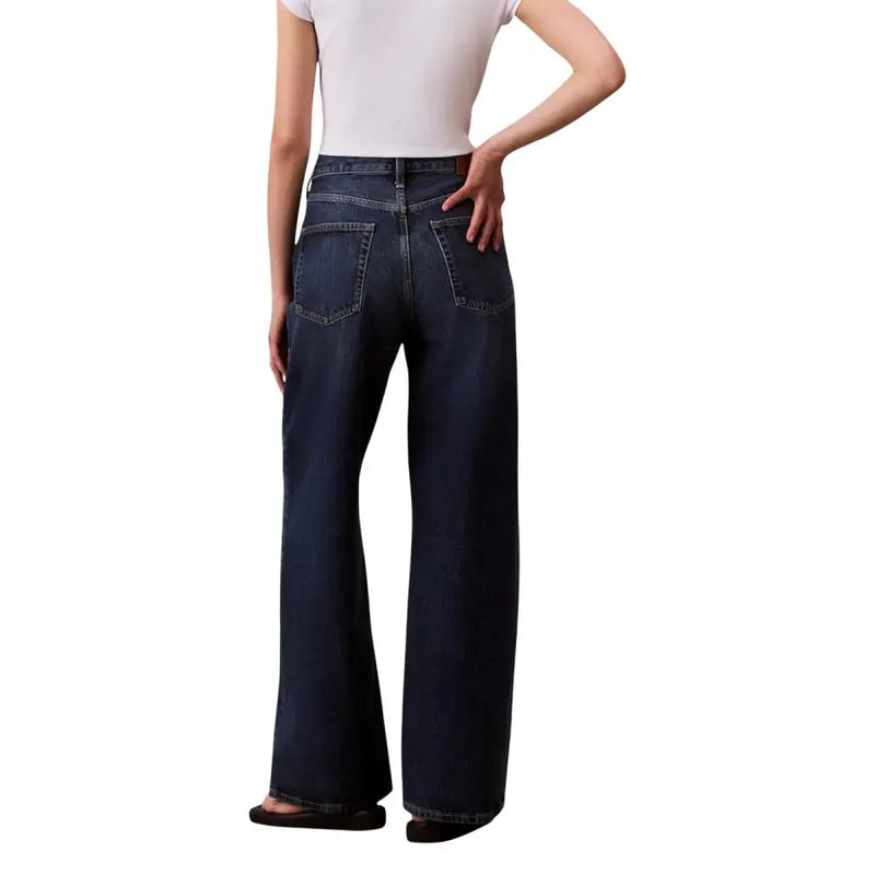 Dark blue wide-leg high waist denim jeans with classic back pockets shown from the back by Calvin Klein women’s fall winter collection