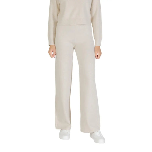 Beige wide-leg knit trousers with soft flowing viscose blend fabric and minimalist design for fall winter wear