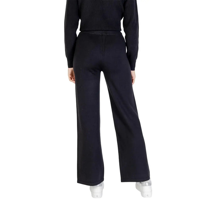 Black wide-leg choral women trousers in viscose blend paired with ribbed knit top featuring sleek silhouette for fall winter