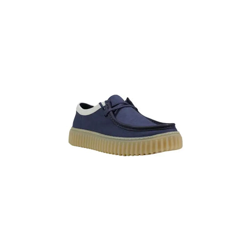 Clarks men lace ups blue fabric shoes featuring navy blue canvas slip-on design with beige ribbed rubber sole and white trim