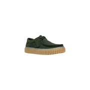 Clarks men slip on shoe in dark green canvas with tan ribbed rubber sole and black laces lightweight fabric design
