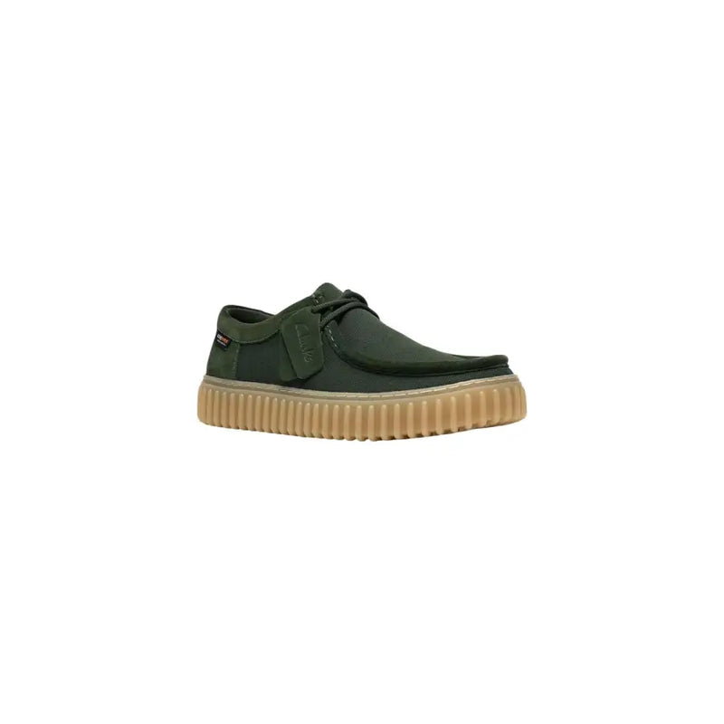 Clarks men slip on shoe in dark green canvas with tan ribbed rubber sole and black laces lightweight fabric design