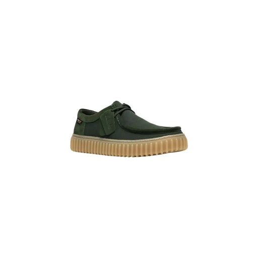Clarks men slip on shoe in dark green canvas with tan ribbed rubber sole and black laces lightweight fabric design
