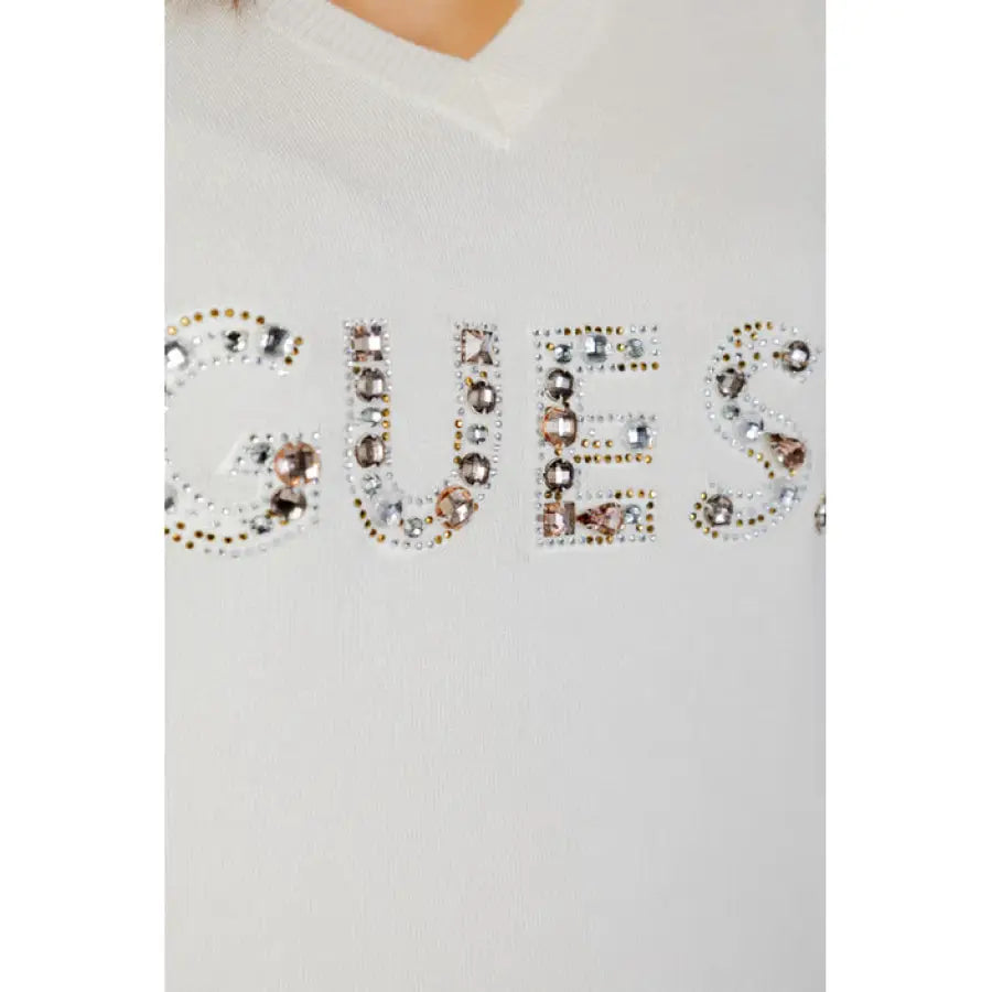 
                      
                        Close-up of Guess women knitwear, white sweater with Guess logo
                      
                    