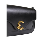 Black leather Chanel handbag with gold-tone interlocking CC clasp and inside pocket by Coccinelle