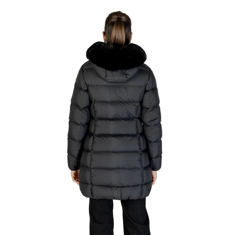 Women wearing a long black puffer coat with fur-trimmed hood from Colmar Originals
