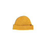 Mustard yellow ribbed beanie with folded cuff and brown leather tag.