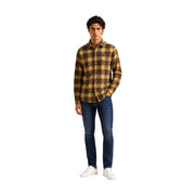 A man wearing a Columbia mens brown polyester plaid shirt jacket with a small chest logo and dark blue jeans