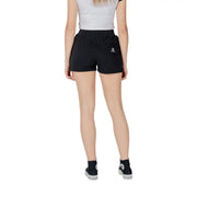 Back view of converse women black cotton fleece shorts featuring a small white star chevron logo on the pocket